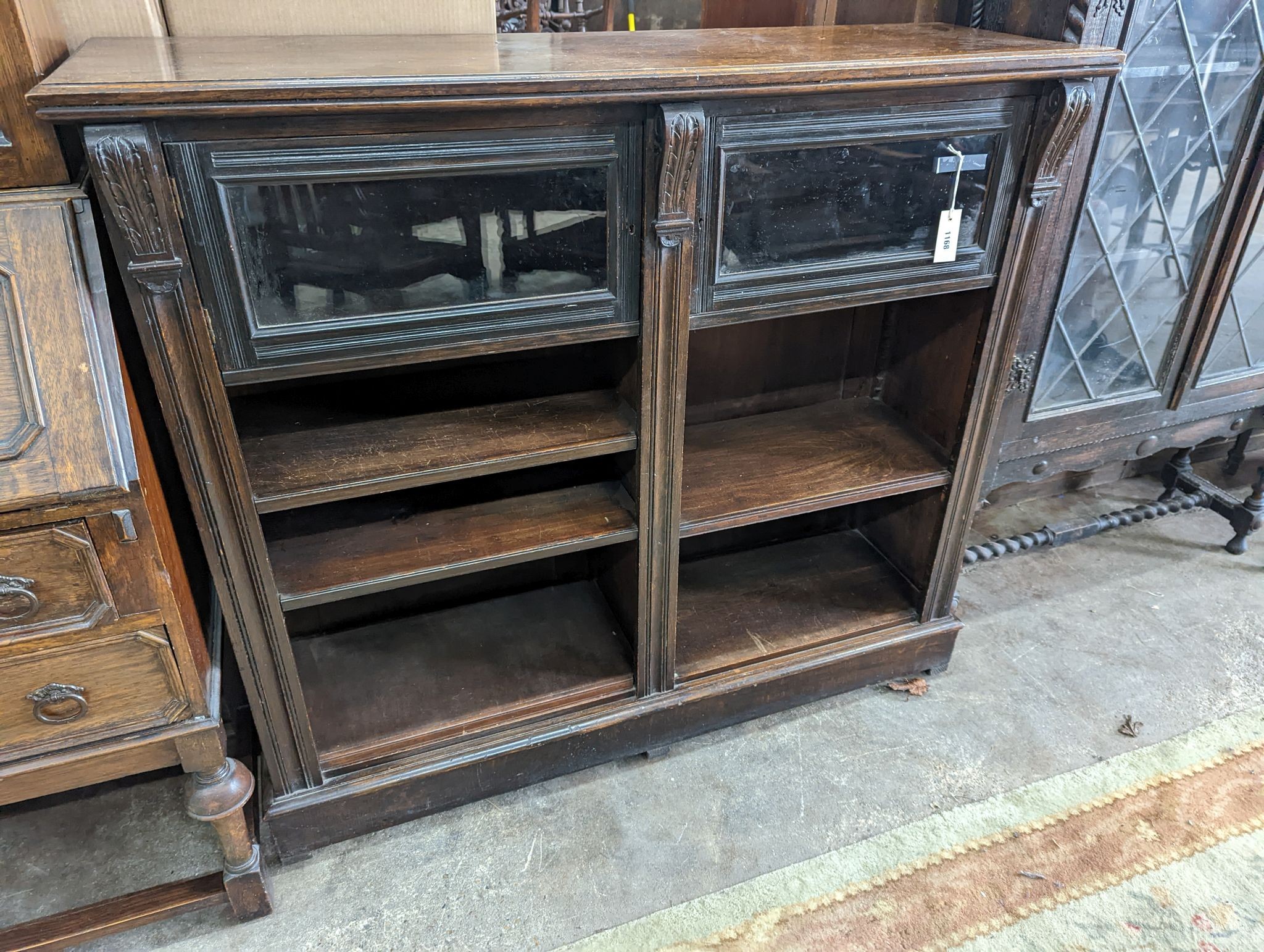 A late Victorian glazed oak bookcase, length 124cm, depth 38cm, height 112cm